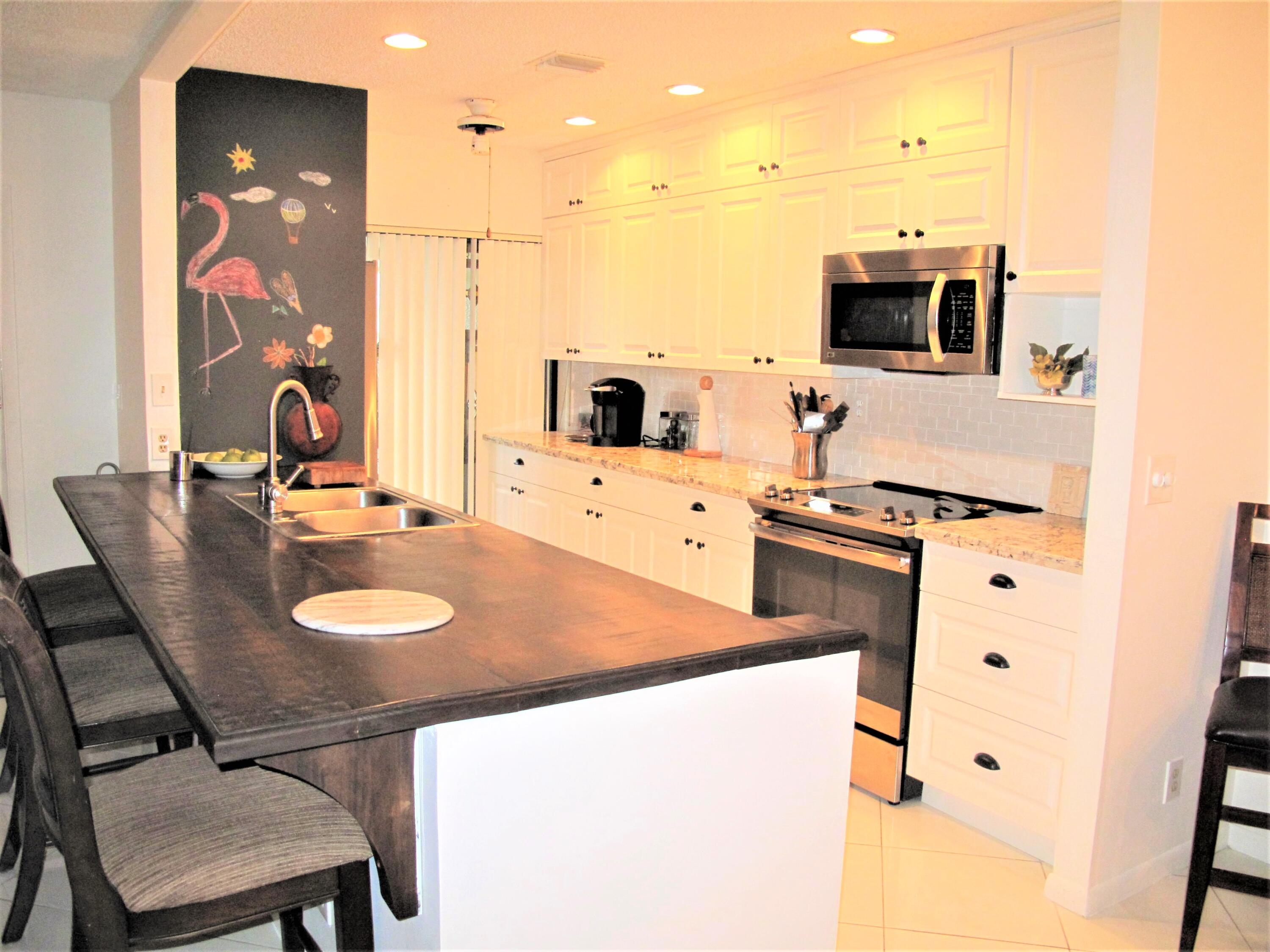 5031 Nesting Way, Unit D Delray Beach, FL 33484 - Photo 9 of 35 Remodeled open concept kitchen