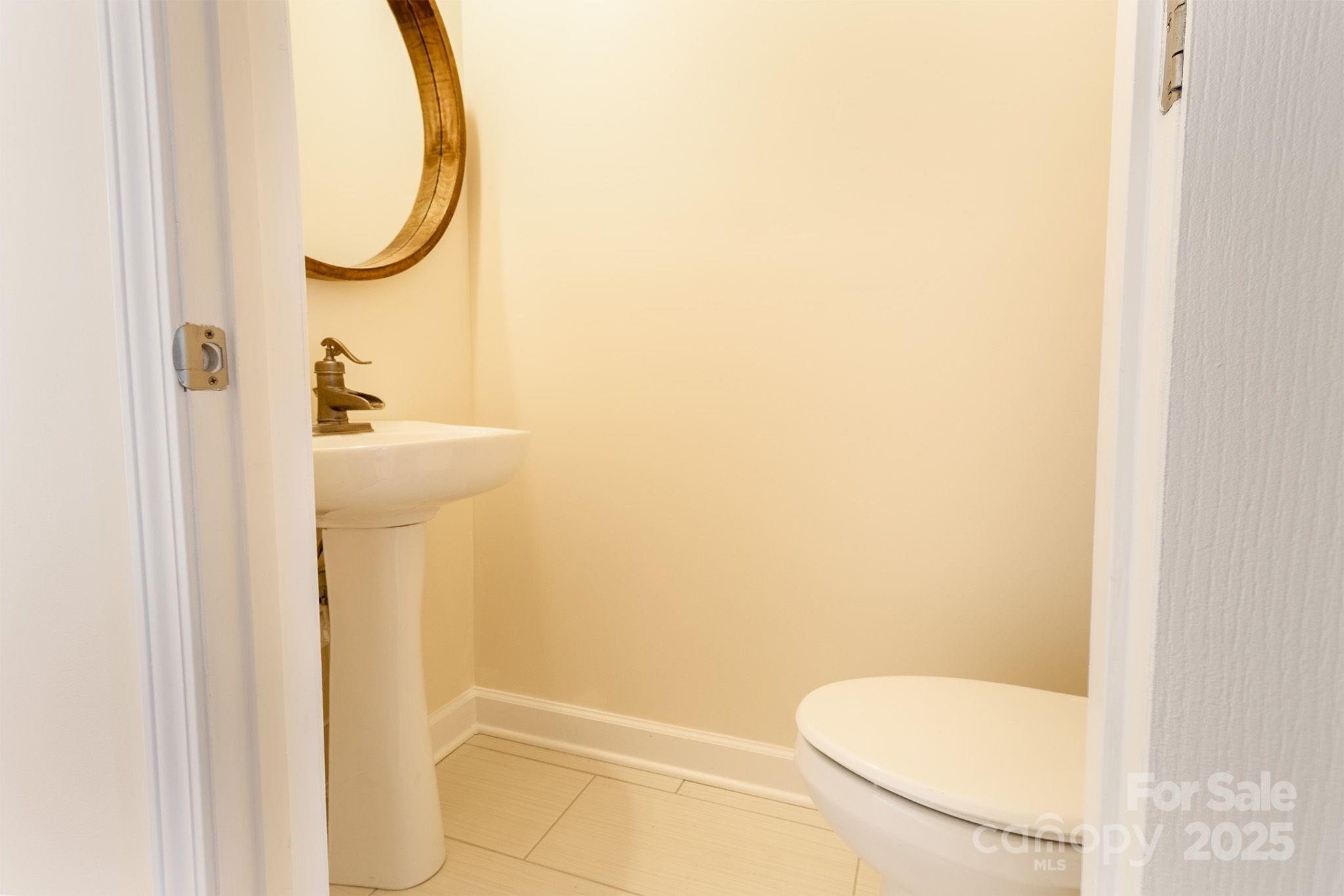 10419 Rocky Ford Club Road Charlotte, NC 28078 - Photo 11 of 37 a bathroom with a sink and toilet