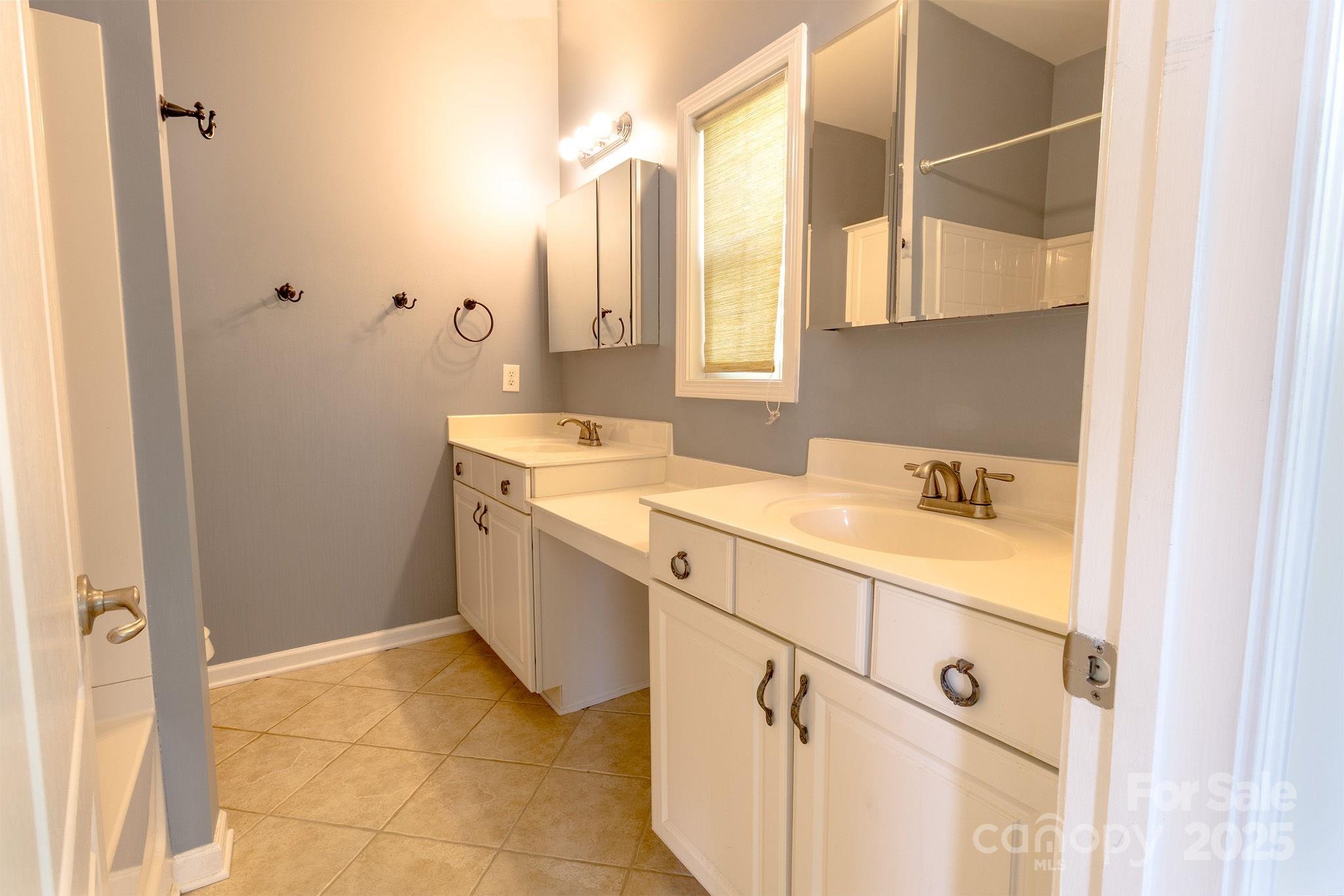 10419 Rocky Ford Club Road Charlotte, NC 28078 - Photo 29 of 37 a bathroom with a sink and a mirror