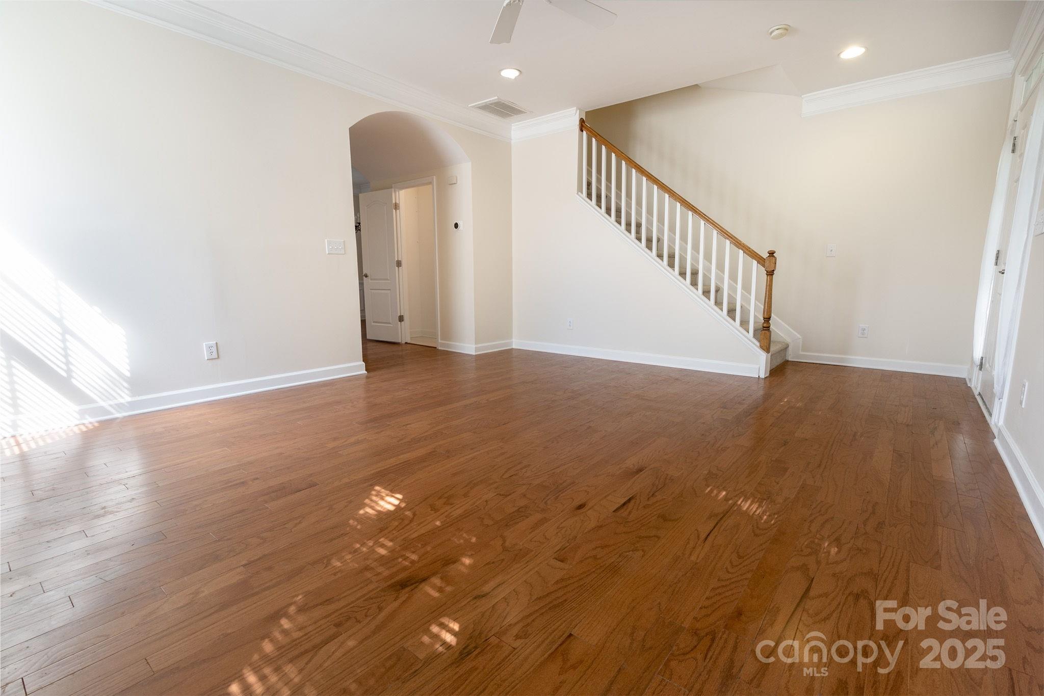 10419 Rocky Ford Club Road Charlotte, NC 28078 - Photo 4 of 37 a view of an empty room with wooden floor and stairs