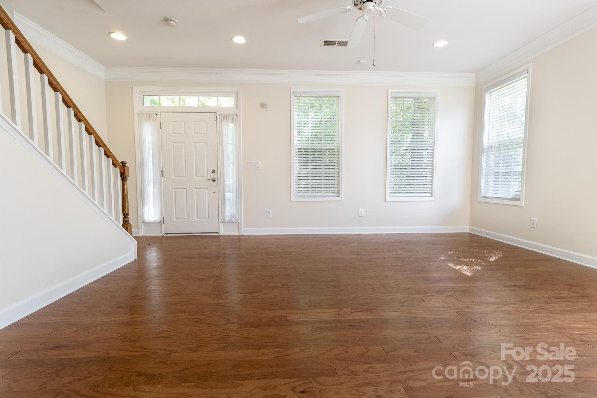 10419 Rocky Ford Club Road Charlotte, NC 28078 - Photo 7 of 37 a view of an empty room with wooden floor and a window