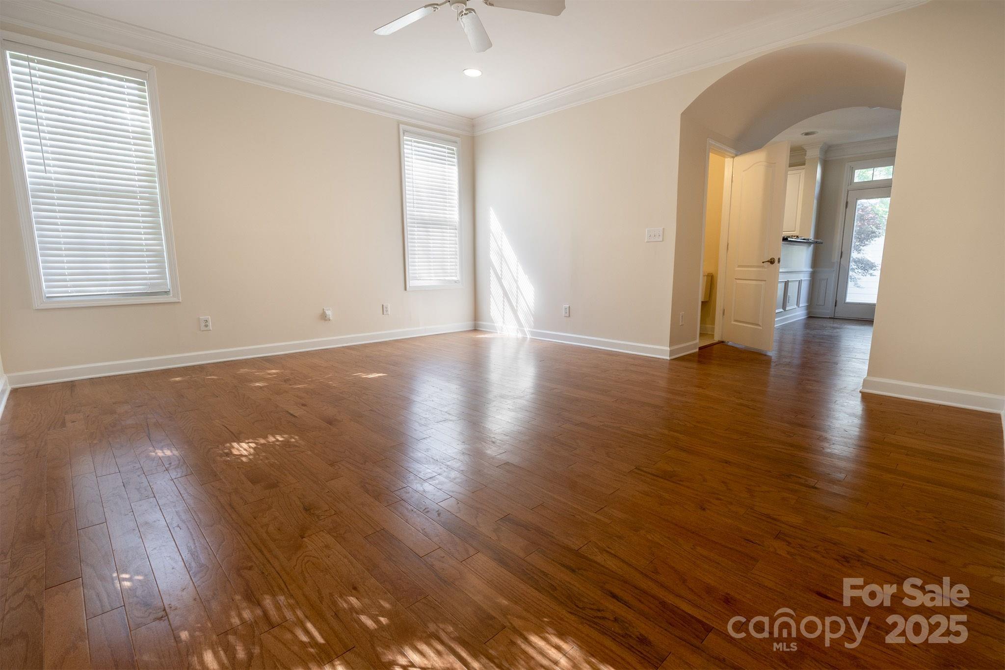 10419 Rocky Ford Club Road Charlotte, NC 28078 - Photo 8 of 37 an empty room with wooden floor and windows