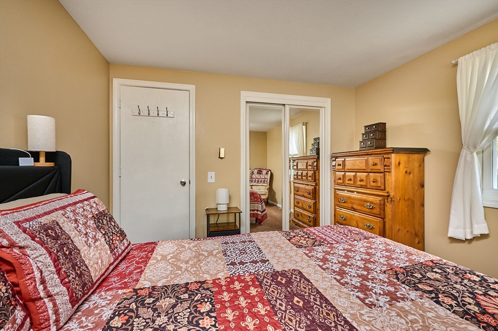 50 Phelps Street Easthampton, MA 01027 - Photo 11 of 38 a bedroom with a bed and a dresser in it