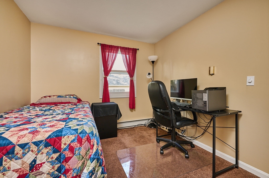 50 Phelps Street Easthampton, MA 01027 - Photo 12 of 38 a bedroom with a bed and a chair