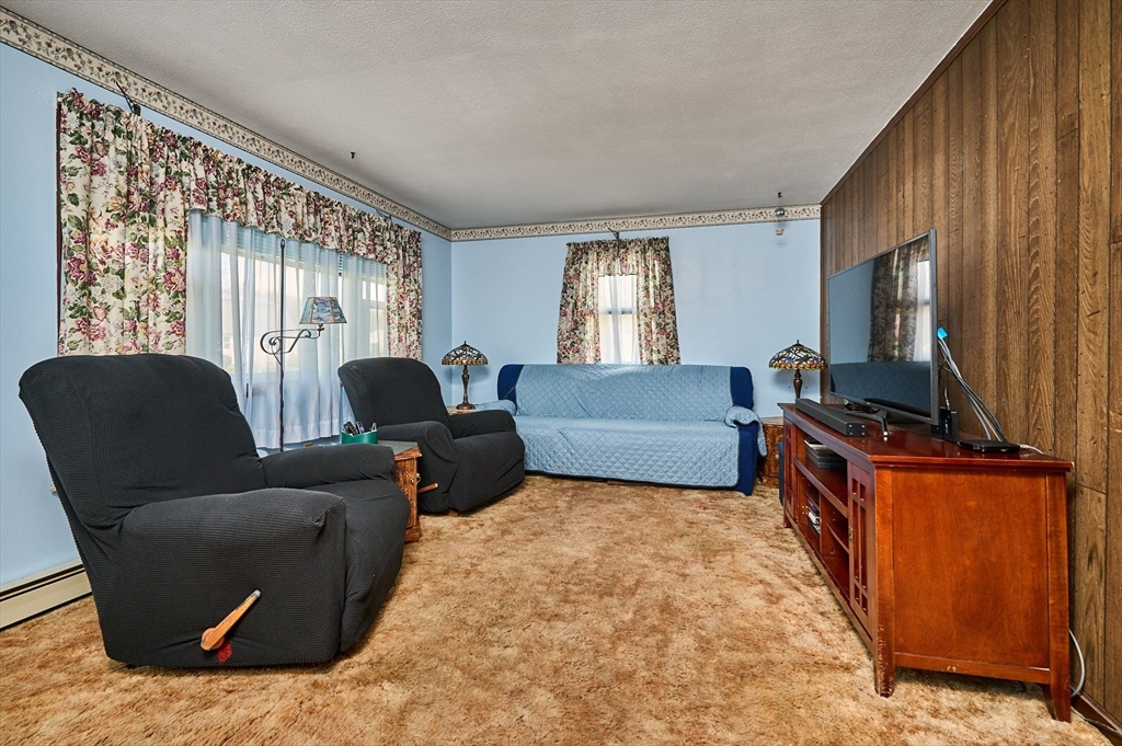 50 Phelps Street Easthampton, MA 01027 - Photo 3 of 38 a living room with furniture and a flat screen tv