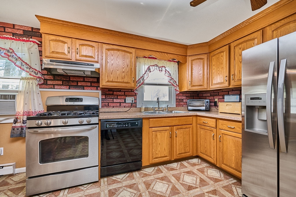 50 Phelps Street Easthampton, MA 01027 - Photo 8 of 38 a kitchen with stainless steel appliances granite countertop a stove a sink and a refrigerator