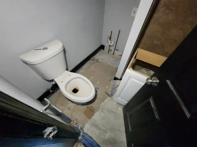 a bathroom with a toilet and a mirror