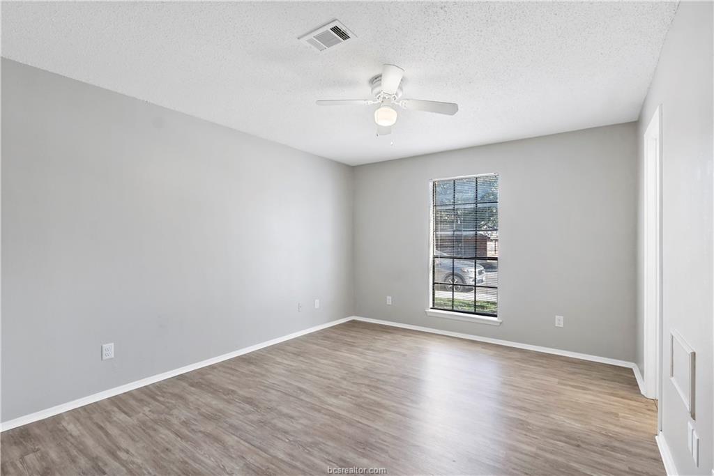 1112 Autumn Circle, Unit B College Station, TX 77840 - Photo 11 of 15 wooden floor in an empty room with a window