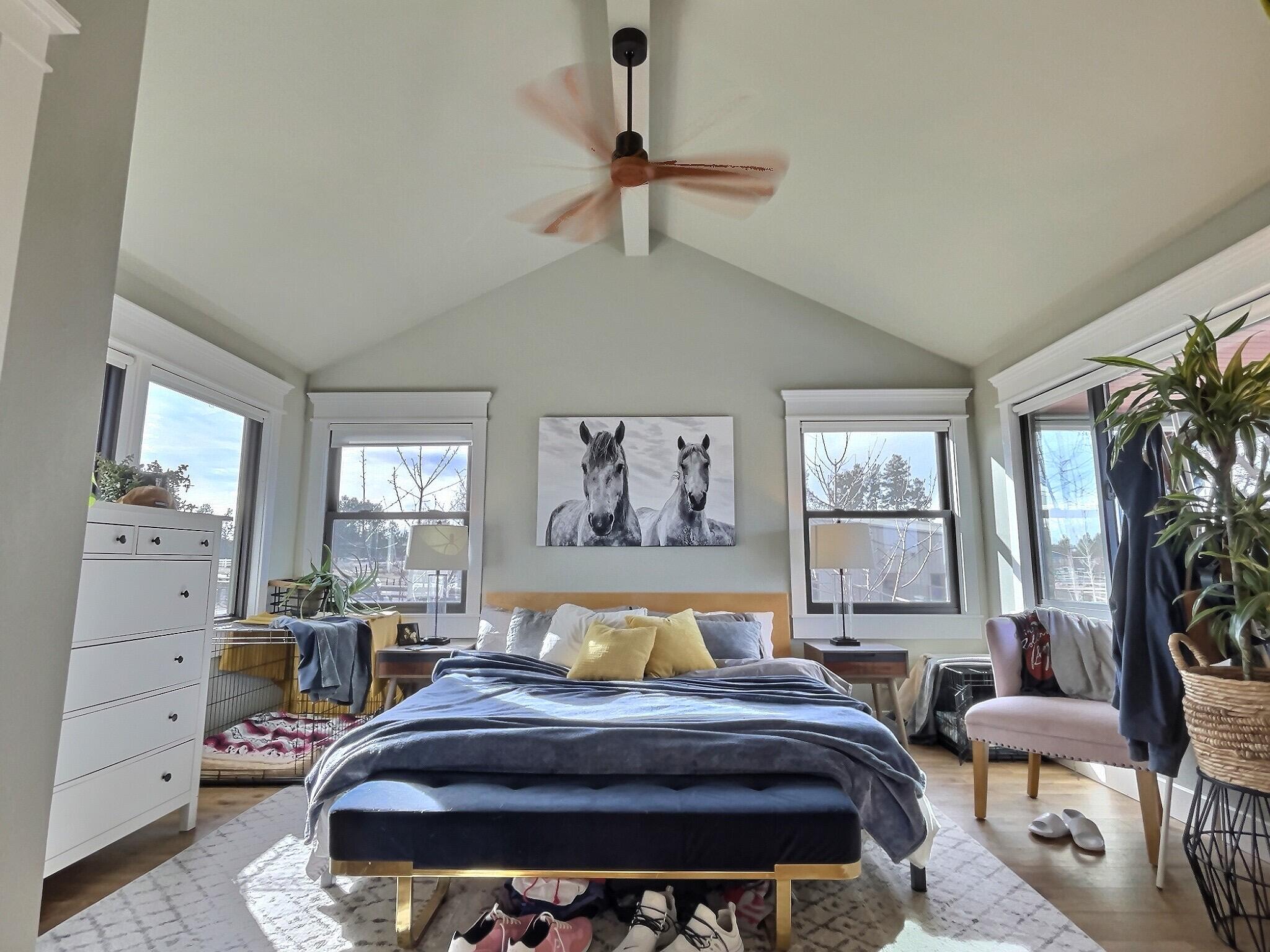 60360 Horse Butte Road Bend, OR 97702 - Photo 22 of 58 a bedroom with a bed a couch and large window