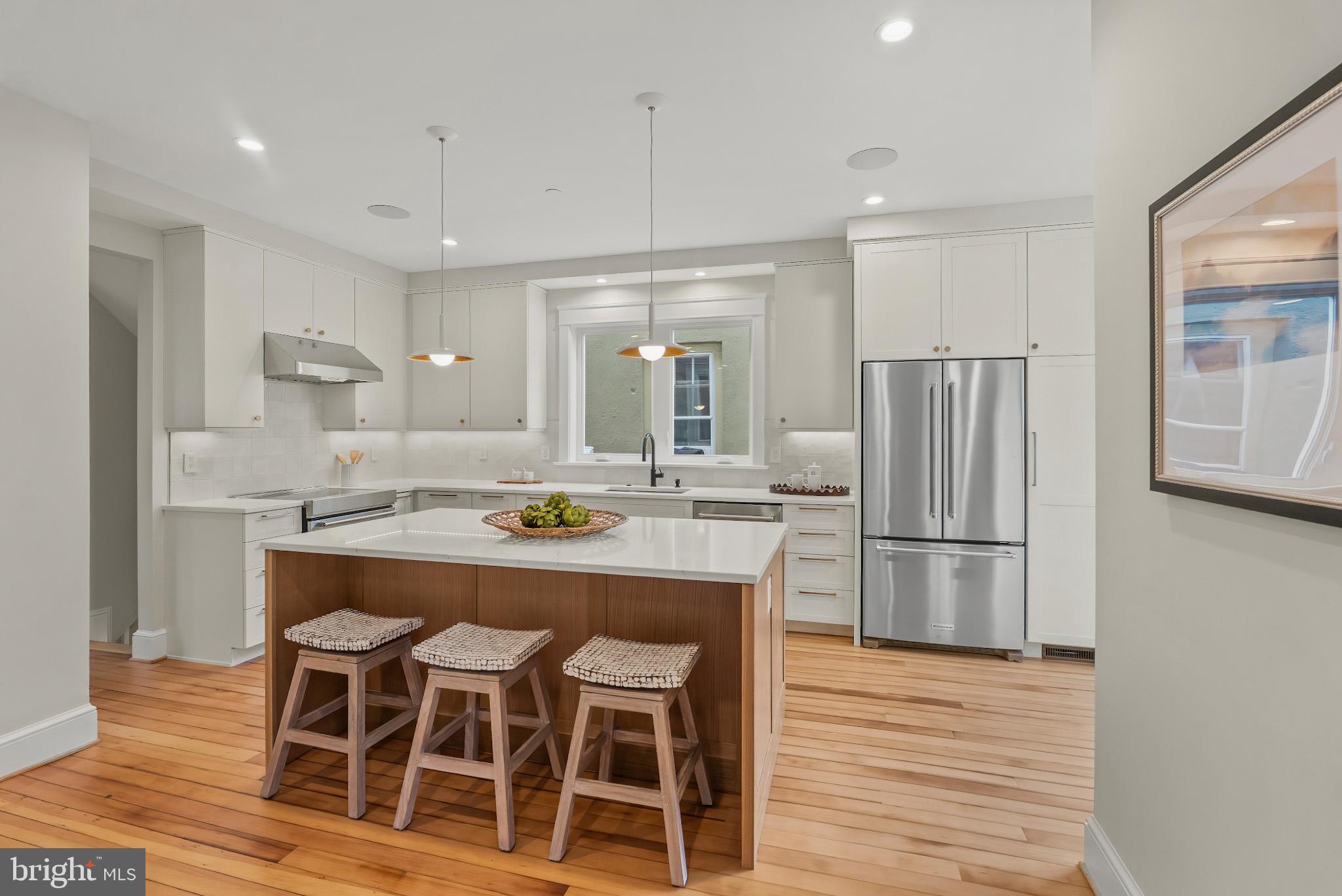 48 Murray Avenue Annapolis, MD 21401 - Photo 13 of 39 a kitchen with kitchen island wooden cabinets and refrigerator
