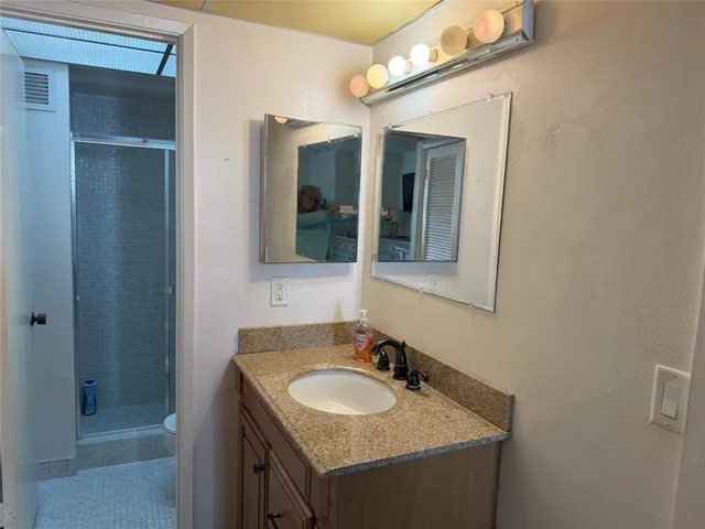 a room with gym equipment and wooden floor