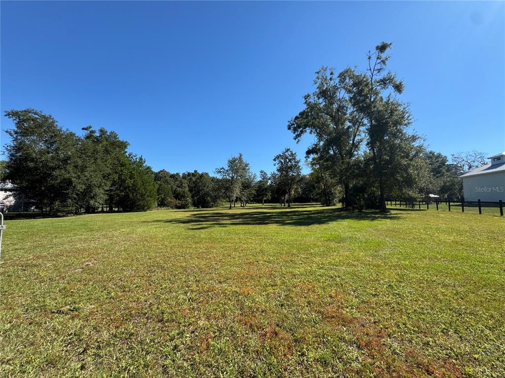 Tbd Northeast 185th Avenue Williston, FL 32696 - Photo 18 of 25 a view of a large yard with a lake