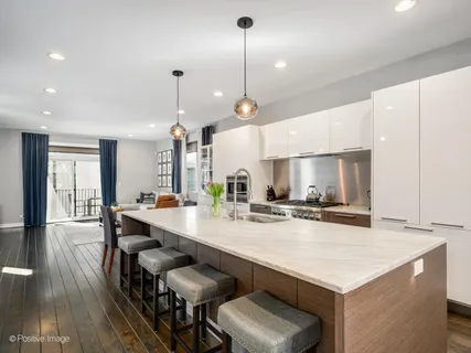 a large kitchen with a table and chairs