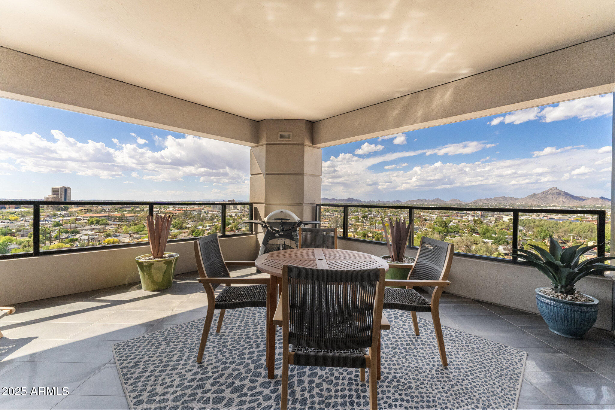 1040 East Osborn Road, Unit 1103 Phoenix, AZ 85014 - Photo 14 of 49 a view of a patio with a dining table and chairs