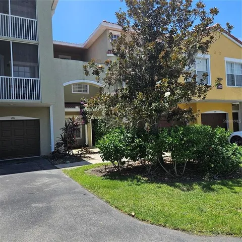 a view of a chair and table in backyard of the house