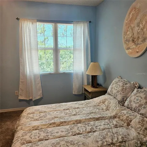 a bedroom with a bed and a lamp