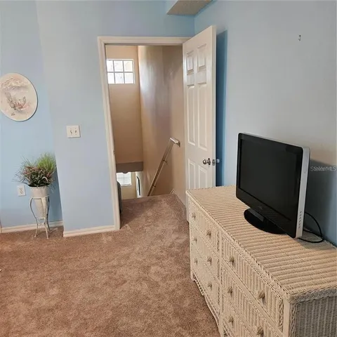 a bathroom with a granite countertop sink a mirror and a toilet