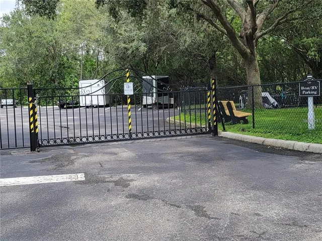 a view of a yard with wooden fence