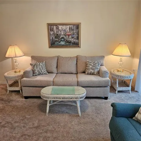 a living room with furniture and a chandelier