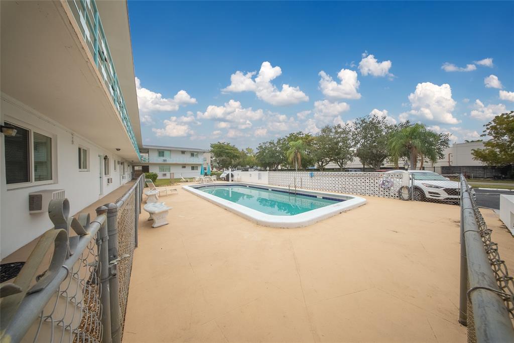 3525 Tyler Street, Unit 9 Hollywood, FL 33021 - Photo 18 of 24 a view of a swimming pool with a yard