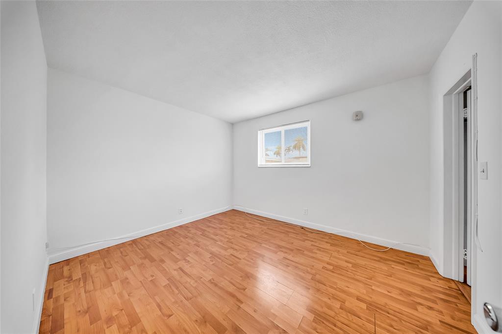 3525 Tyler Street, Unit 9 Hollywood, FL 33021 - Photo 10 of 24 a view of empty room with wooden floor