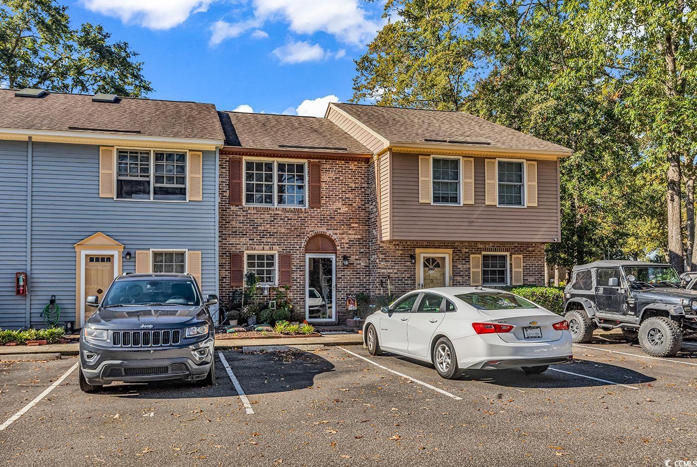 830 44th Avenue North, Unit I5 Myrtle Beach, SC 29577 - Photo 1 of 27 View of front of property with uncovered parking, roof with shingles, and brick siding