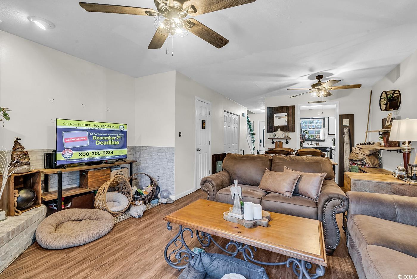830 44th Avenue North, Unit I5 Myrtle Beach, SC 29577 - Photo 12 of 27 Living room featuring wood finished floors and a ceiling fan