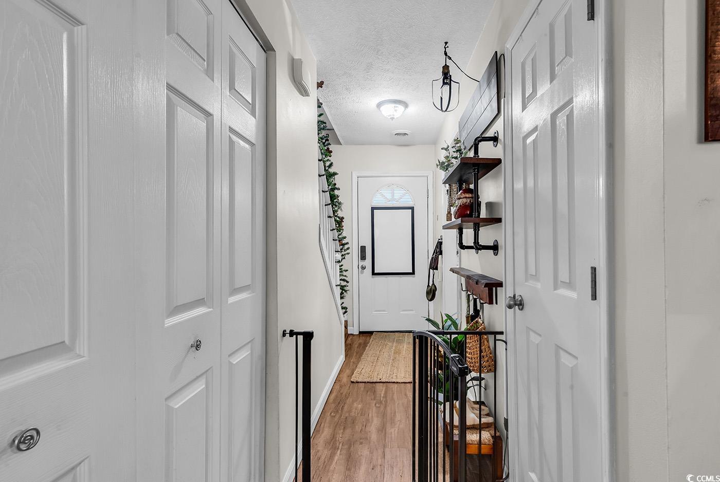 830 44th Avenue North, Unit I5 Myrtle Beach, SC 29577 - Photo 13 of 27 Hall with wood finished floors and a textured ceiling