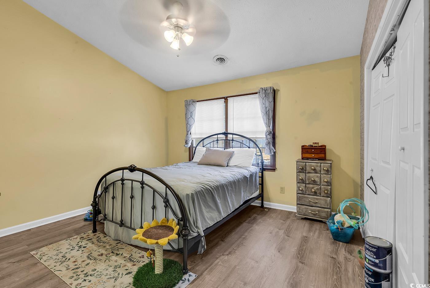 830 44th Avenue North, Unit I5 Myrtle Beach, SC 29577 - Photo 14 of 27 Bedroom with wood finished floors, a closet, and a ceiling fan