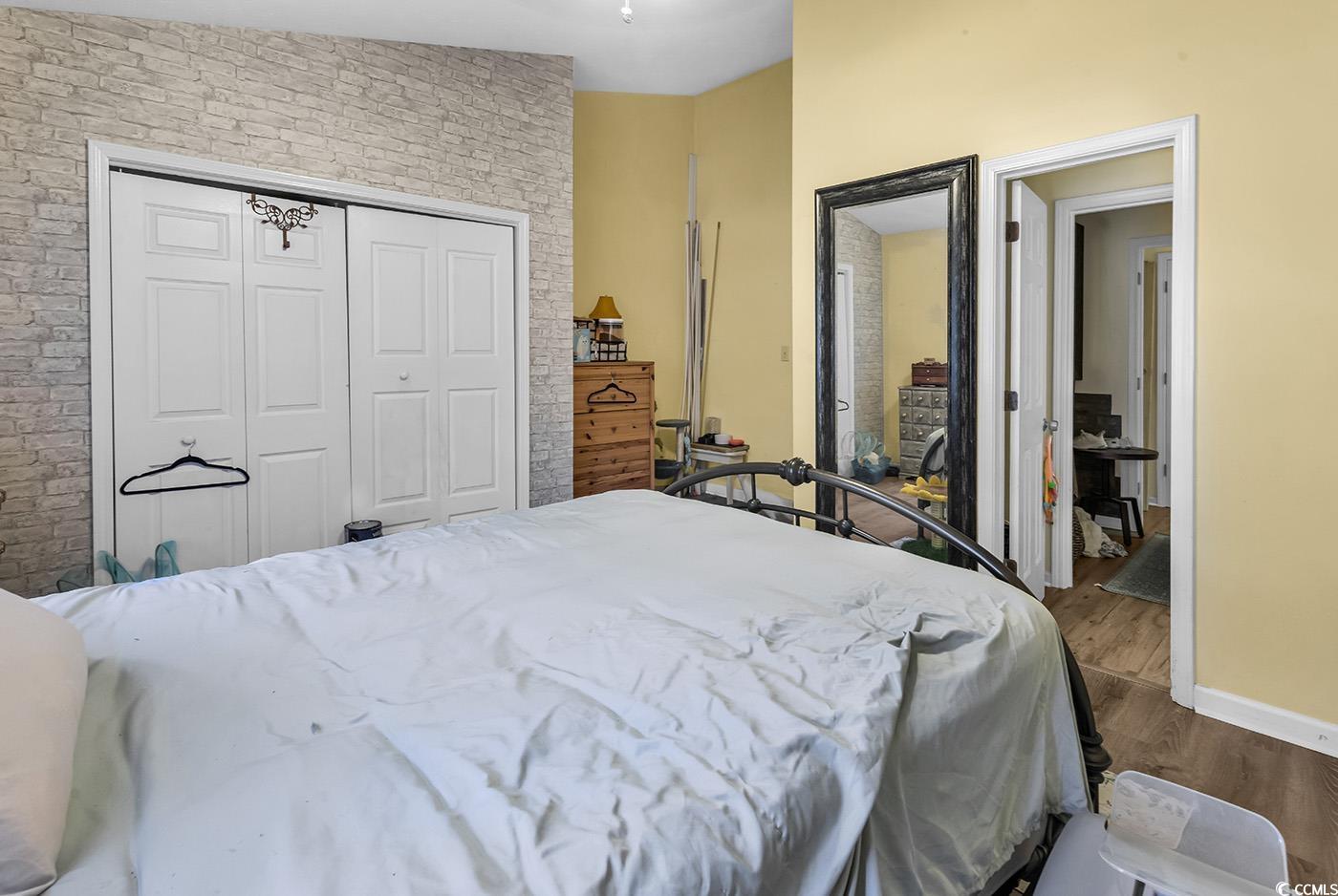 830 44th Avenue North, Unit I5 Myrtle Beach, SC 29577 - Photo 15 of 27 Bedroom featuring wood finished floors and a closet