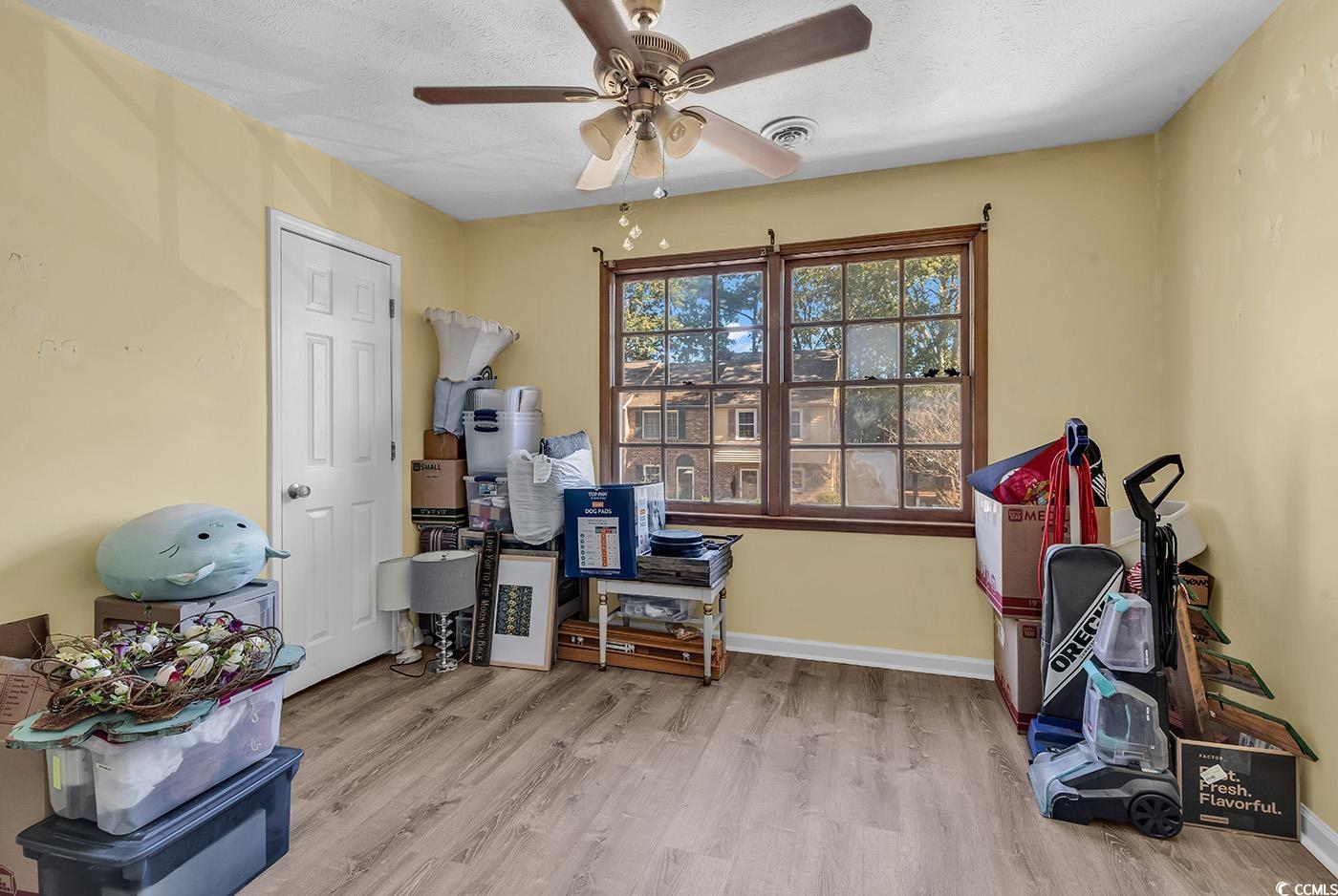 830 44th Avenue North, Unit I5 Myrtle Beach, SC 29577 - Photo 17 of 27 Misc room featuring light wood-type flooring, ceiling fan, and a textured ceiling