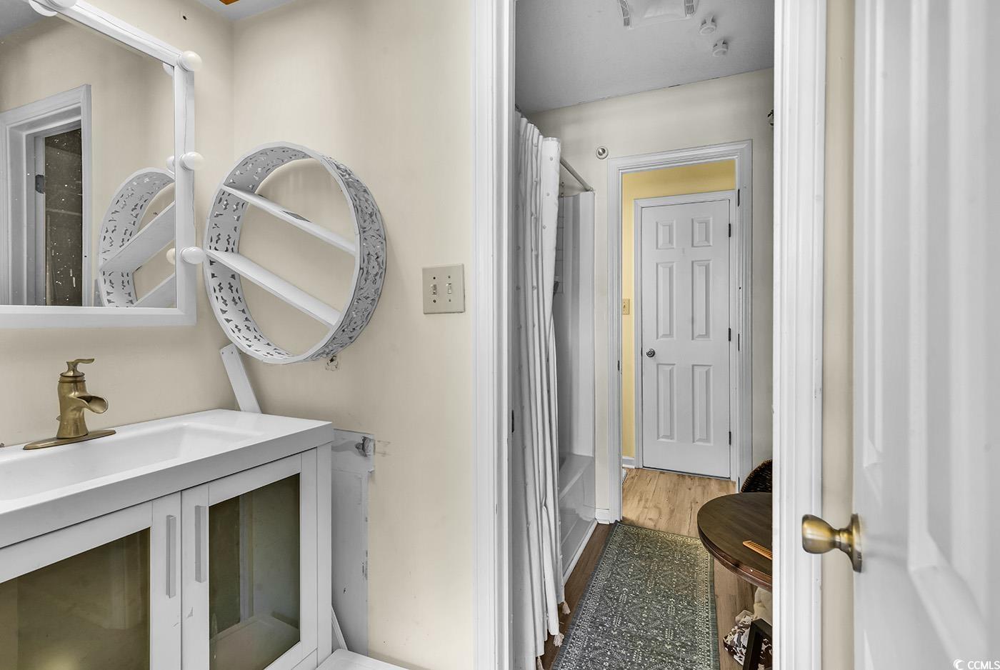 830 44th Avenue North, Unit I5 Myrtle Beach, SC 29577 - Photo 18 of 27 Bathroom with vanity, dark wood finished floors, and shower / tub combo with curtain