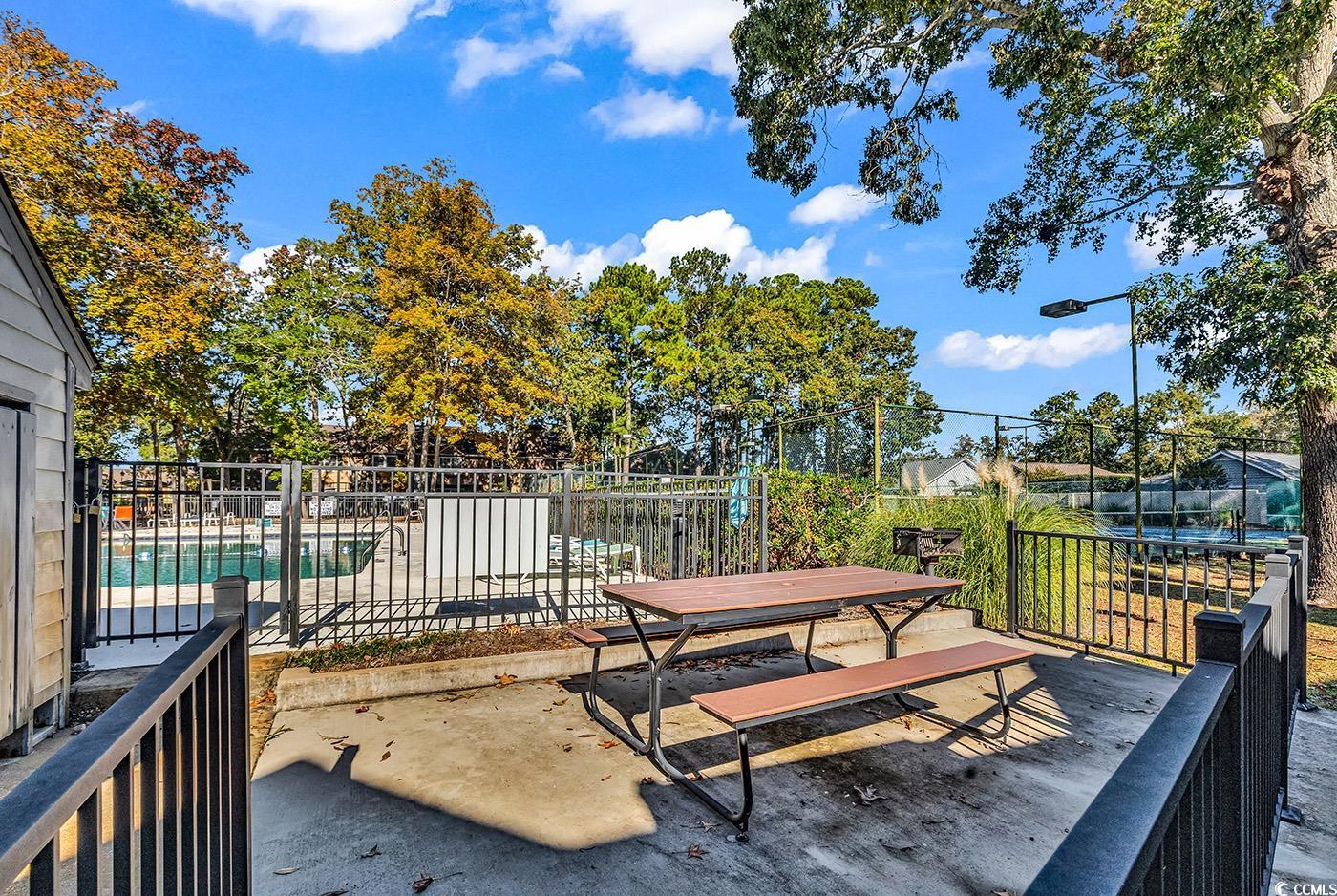 830 44th Avenue North, Unit I5 Myrtle Beach, SC 29577 - Photo 26 of 27 Wooden deck with a patio area and outdoor dining area