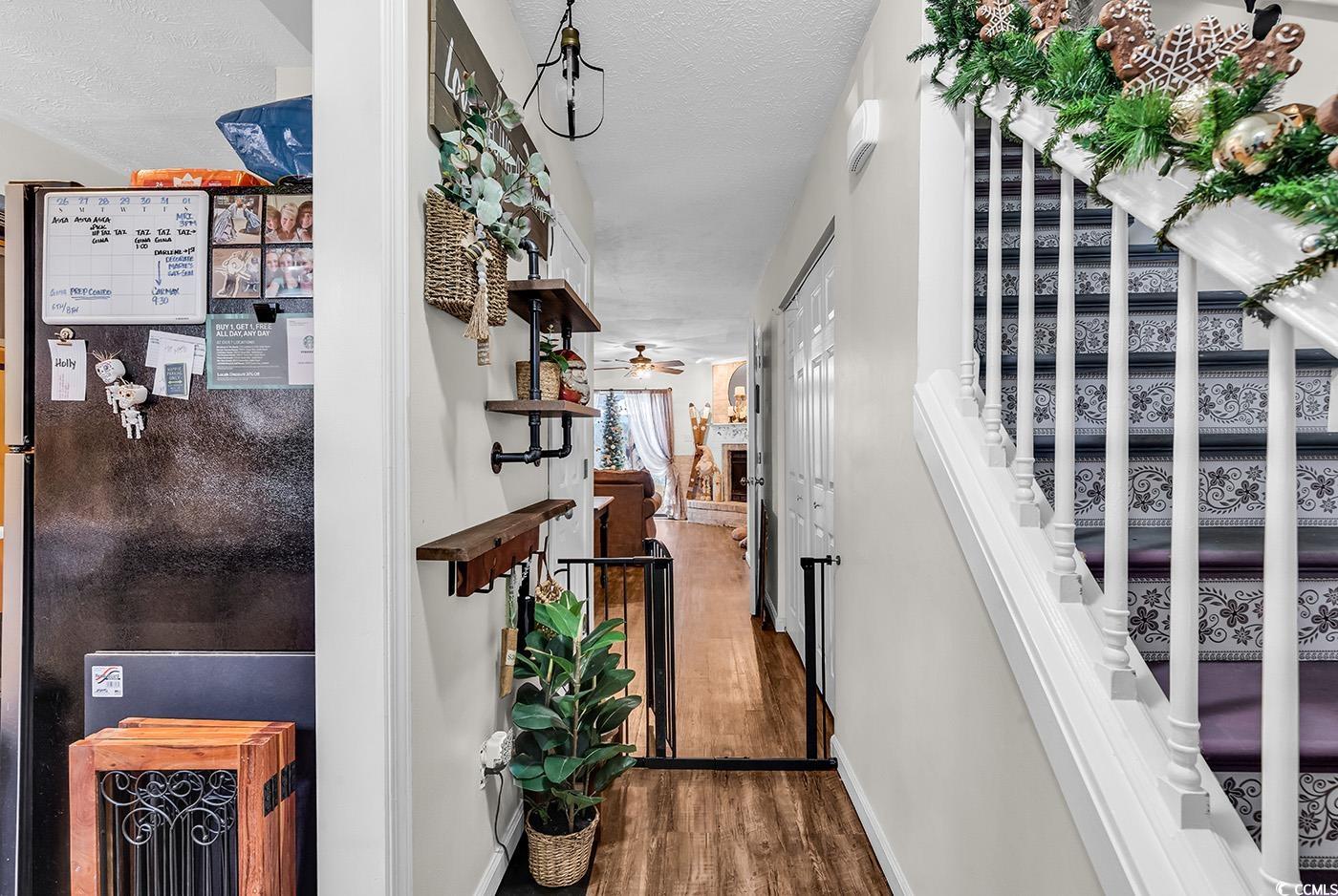 830 44th Avenue North, Unit I5 Myrtle Beach, SC 29577 - Photo 3 of 27 Corridor featuring stairs, dark wood-style floors, and a textured ceiling