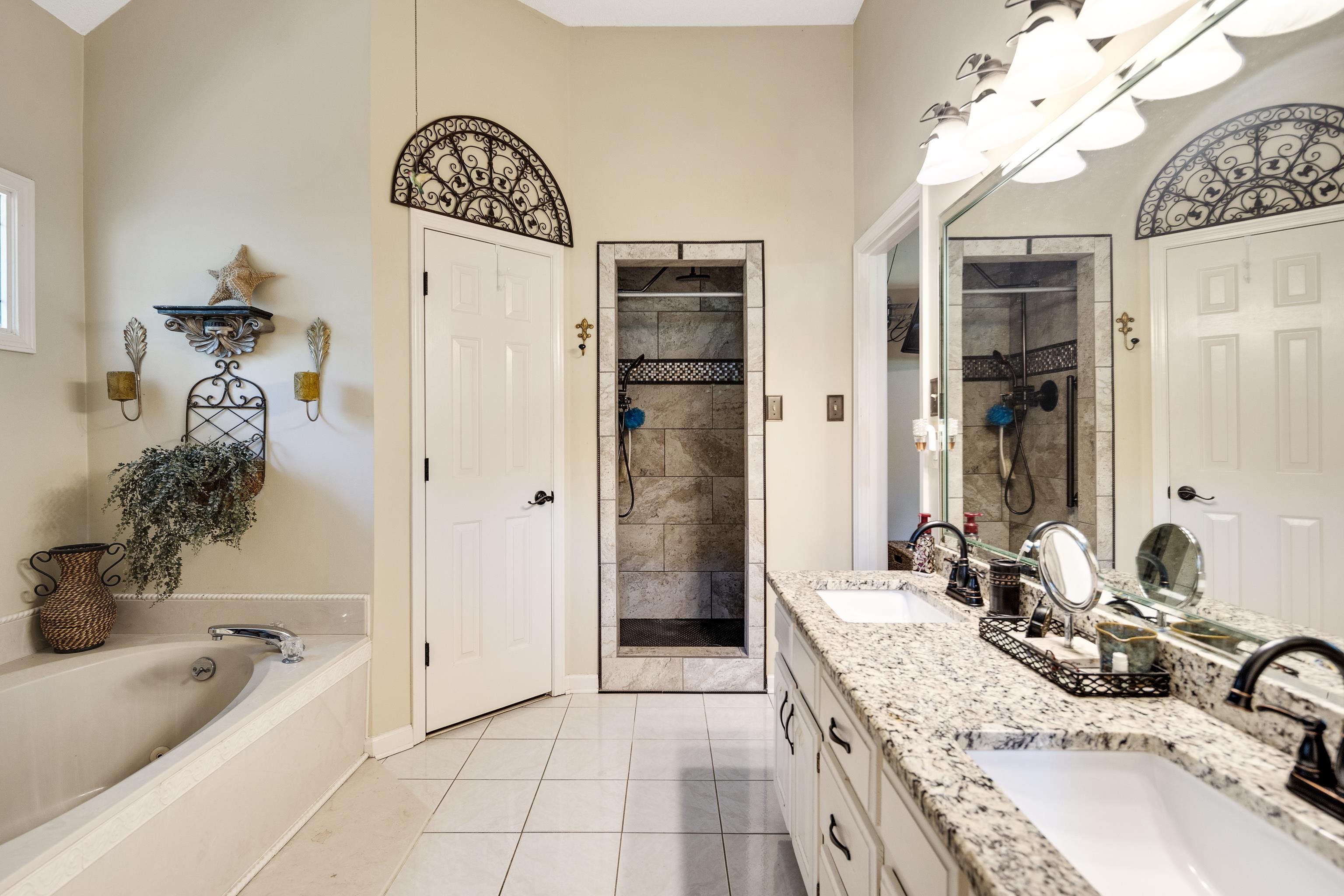 6119 Brunswick Road Arlington, TN 38002 - Photo 19 of 39 a spacious bathroom with a tub sink and mirror