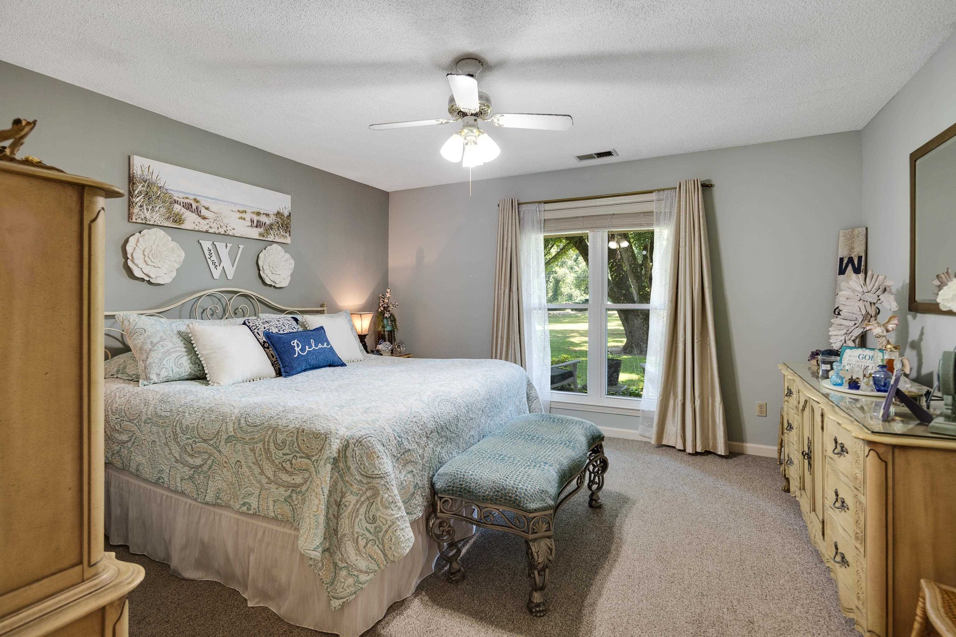 6119 Brunswick Road Arlington, TN 38002 - Photo 21 of 39 a bedroom with a bed and a chandelier