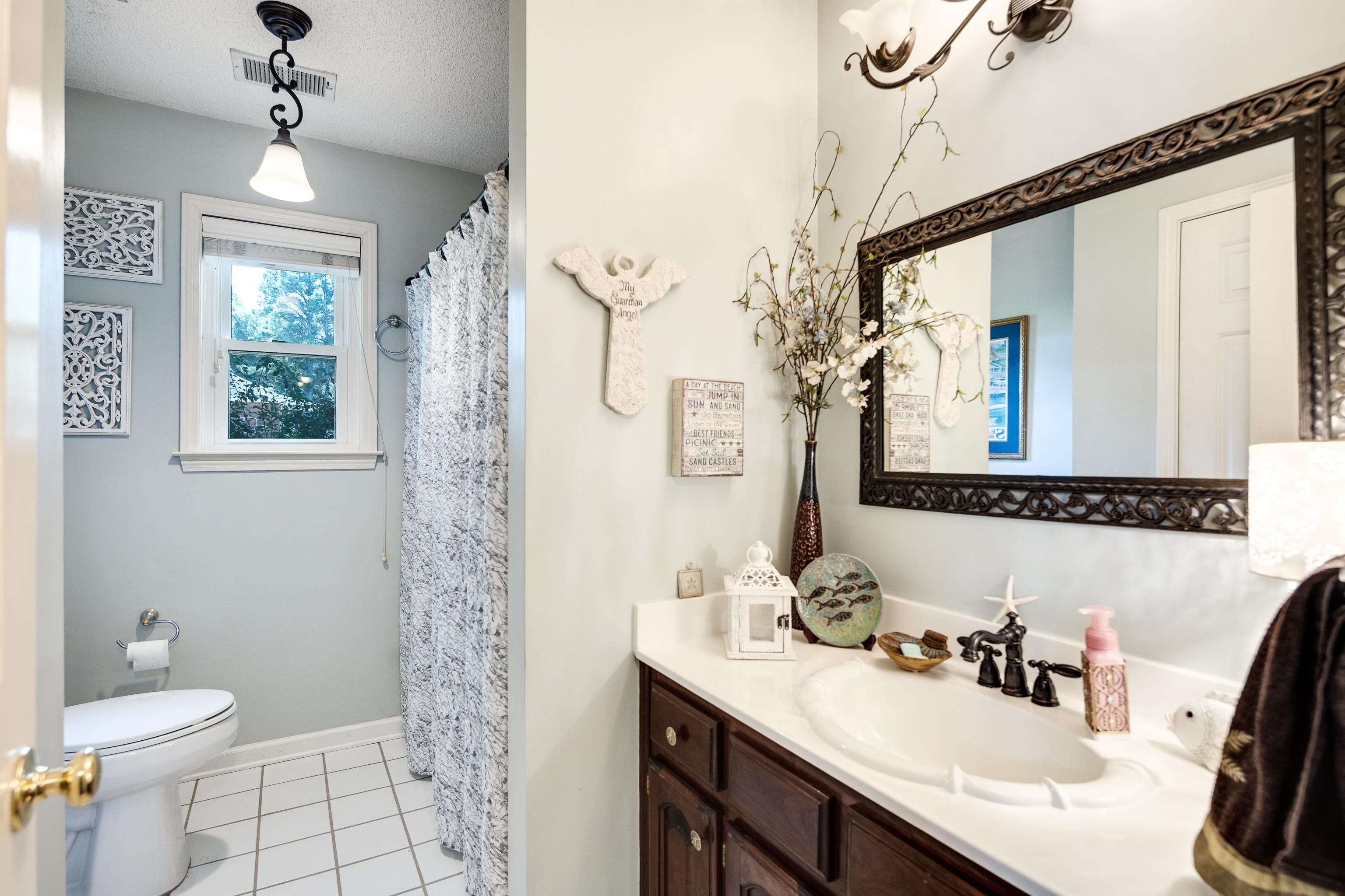 6119 Brunswick Road Arlington, TN 38002 - Photo 23 of 39 a bathroom with a sink a toilet and a mirror