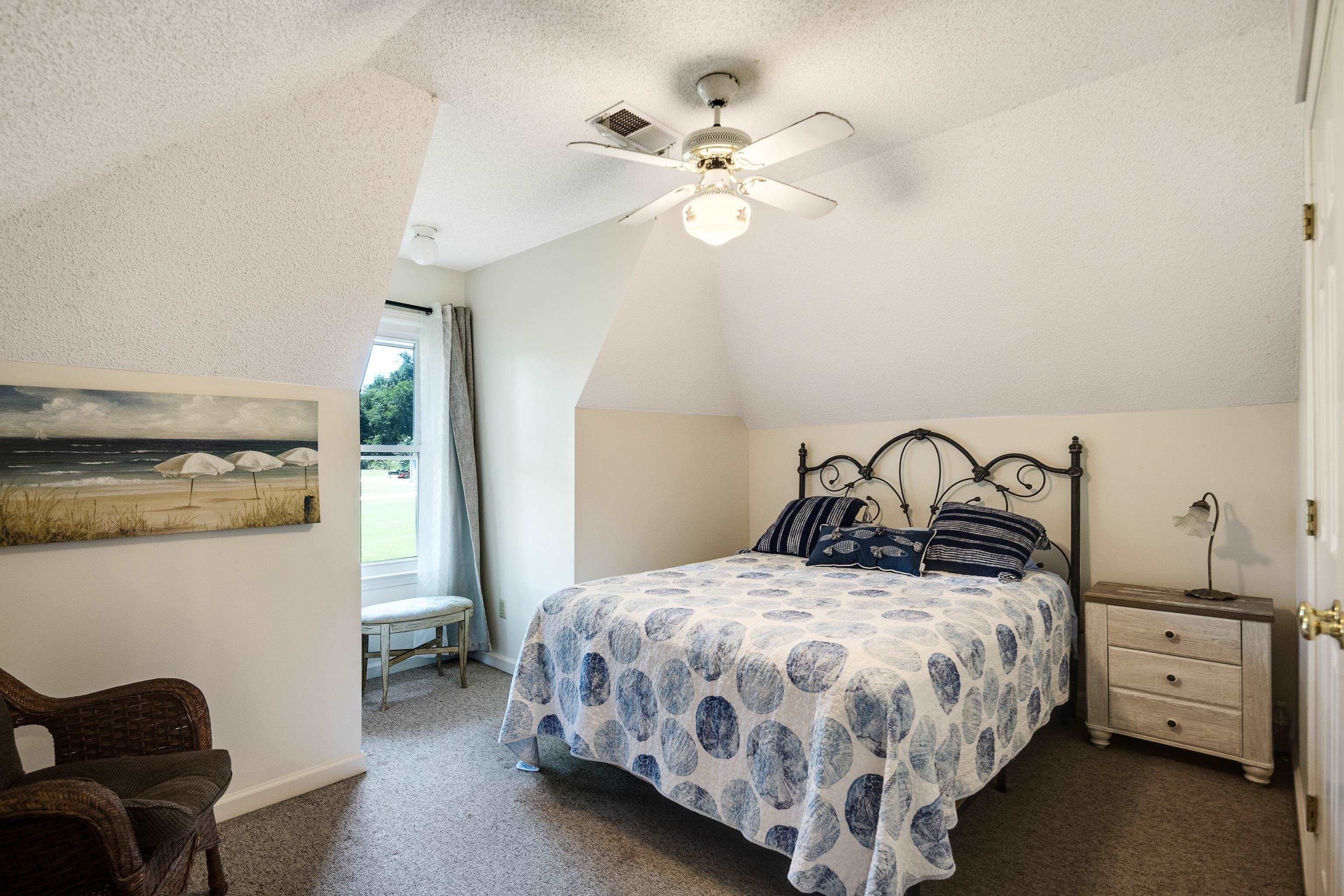 6119 Brunswick Road Arlington, TN 38002 - Photo 26 of 39 a bedroom with a bed and a chandelier
