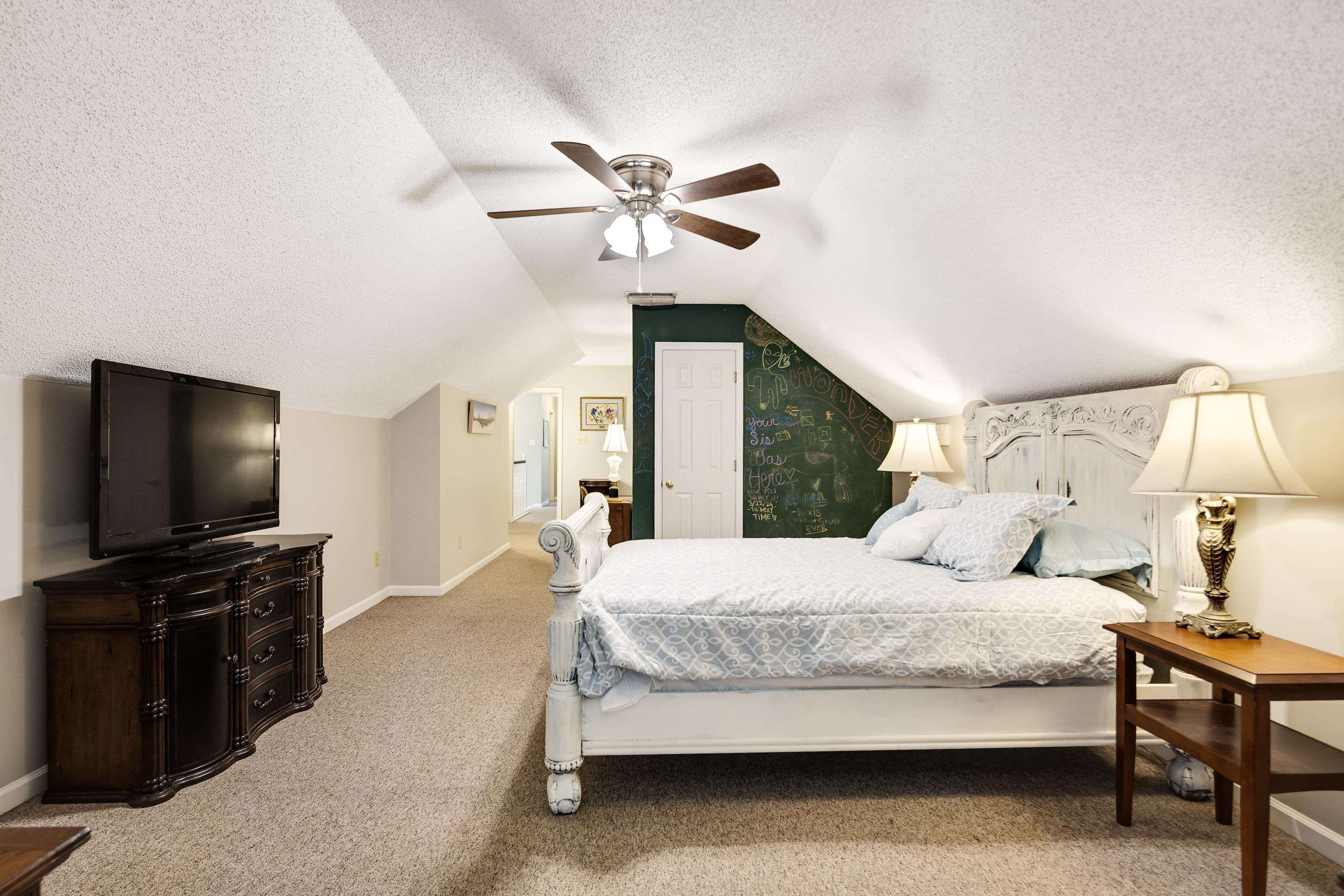 6119 Brunswick Road Arlington, TN 38002 - Photo 27 of 39 a bedroom with a bed and a flat screen tv