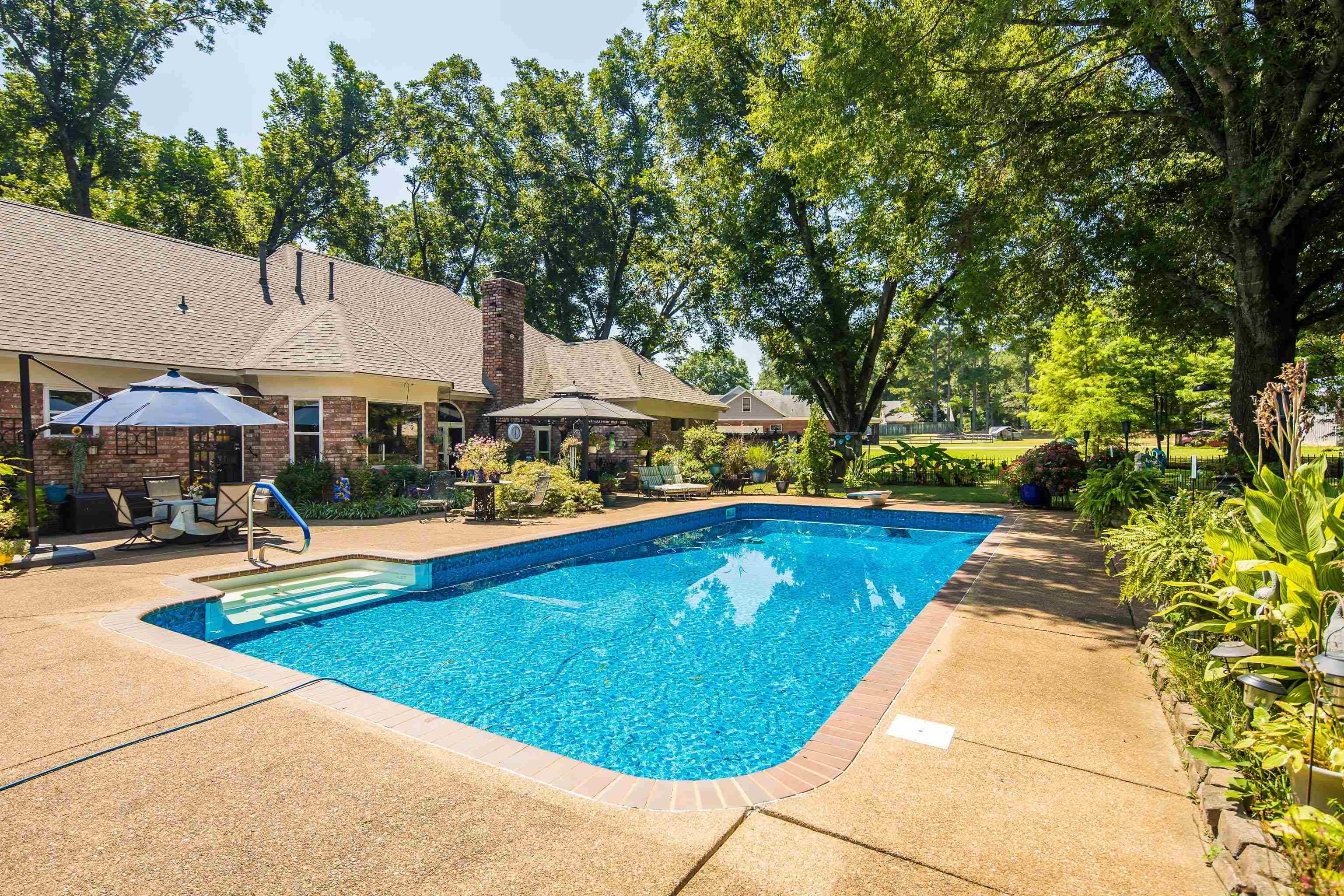 6119 Brunswick Road Arlington, TN 38002 - Photo 30 of 39 a view of swimming pool with seating area and trees in the background