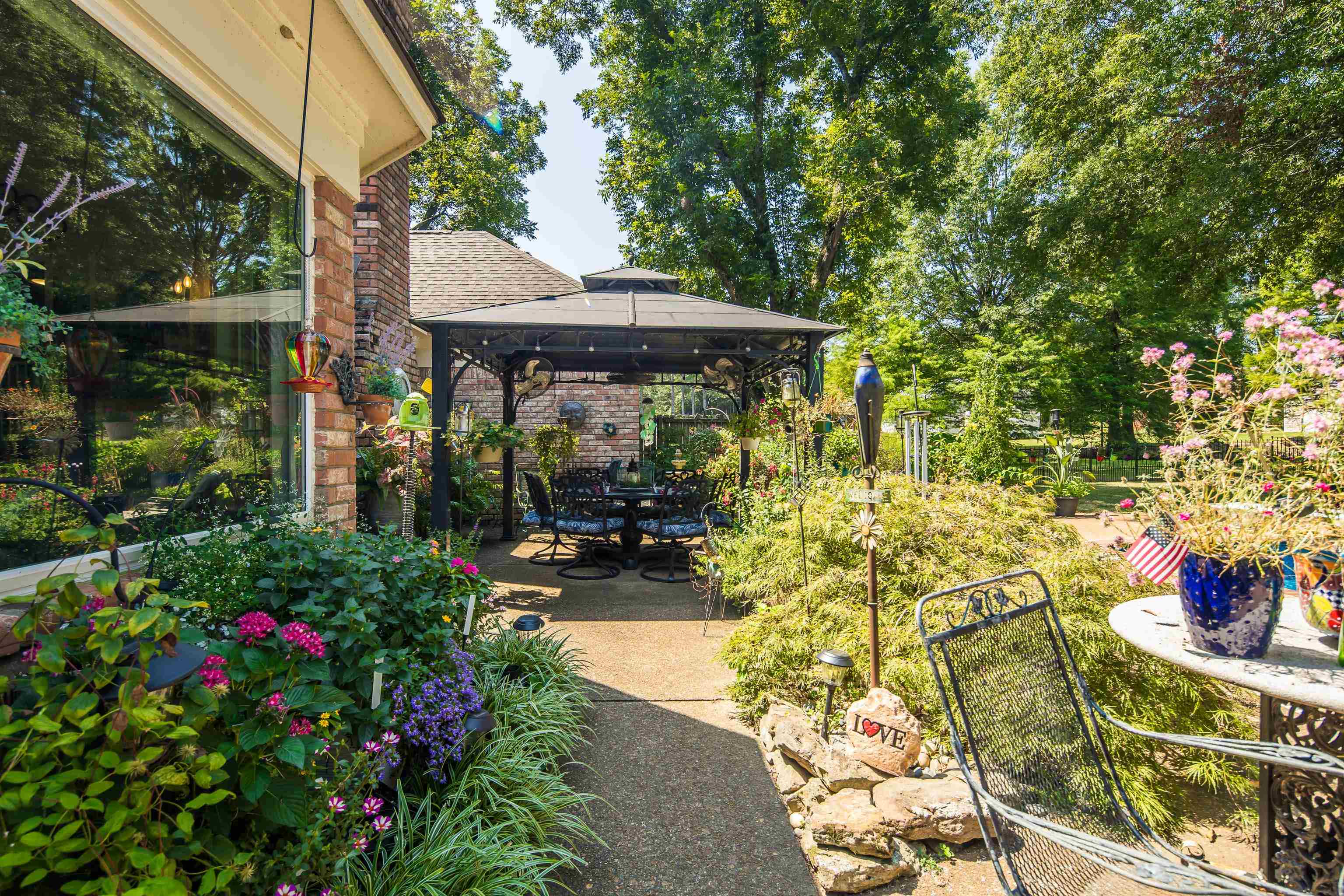 6119 Brunswick Road Arlington, TN 38002 - Photo 32 of 39 a view of a patio with table and chairs potted plants