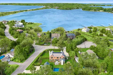 an aerial view of a house with a lake view