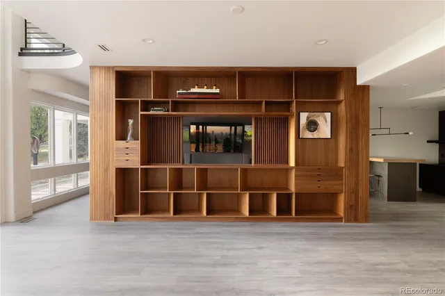 a living room with furniture and a floor to ceiling window