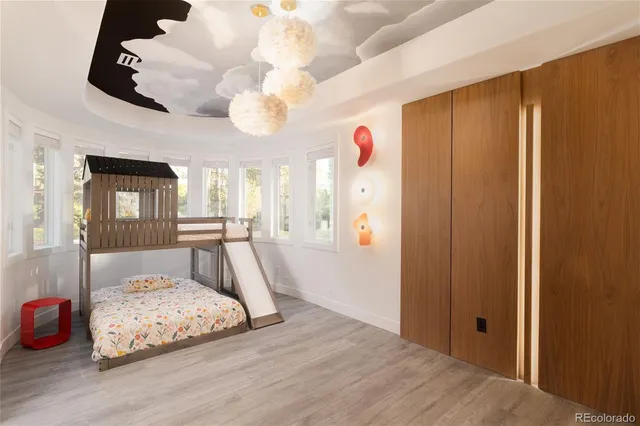 a living room with furniture and large windows