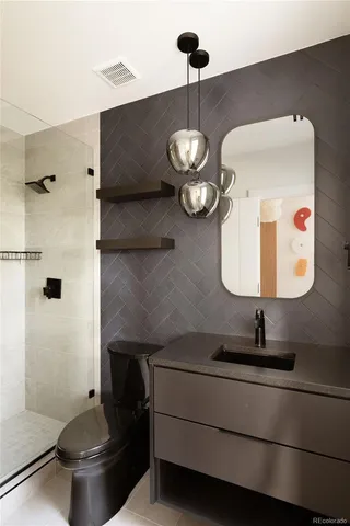 a view of an empty room with furniture and a window