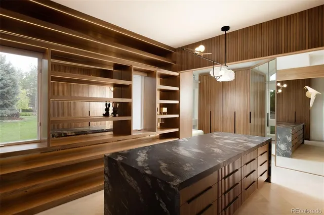 a bathroom with a sink a large mirror and vanity