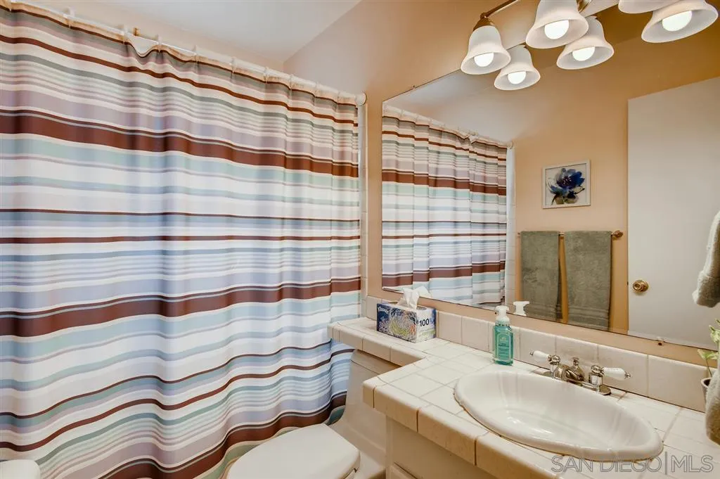 9809 Medina Drive Santee, CA 92071 - Photo 21 of 22 a bathroom with a sink and a mirror