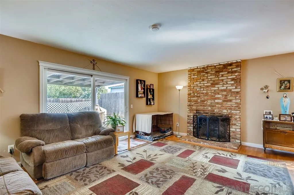 9809 Medina Drive Santee, CA 92071 - Photo 4 of 22 a living room with furniture a rug and a fireplace