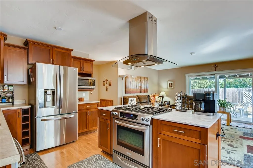 9809 Medina Drive Santee, CA 92071 - Photo 9 of 22 a kitchen with stainless steel appliances a stove a refrigerator and a stove
