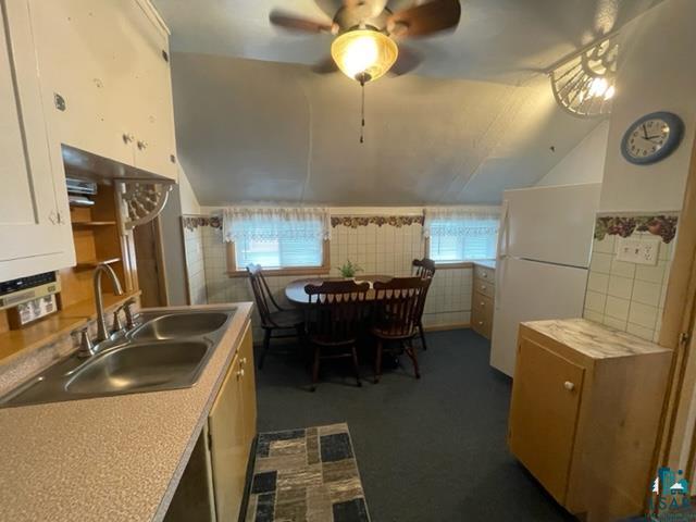 32 West Shagawa Road Ely, MN 55731 - Photo 15 of 26 Kitchen with ceiling fan, sink, white fridge, and plenty of natural light
